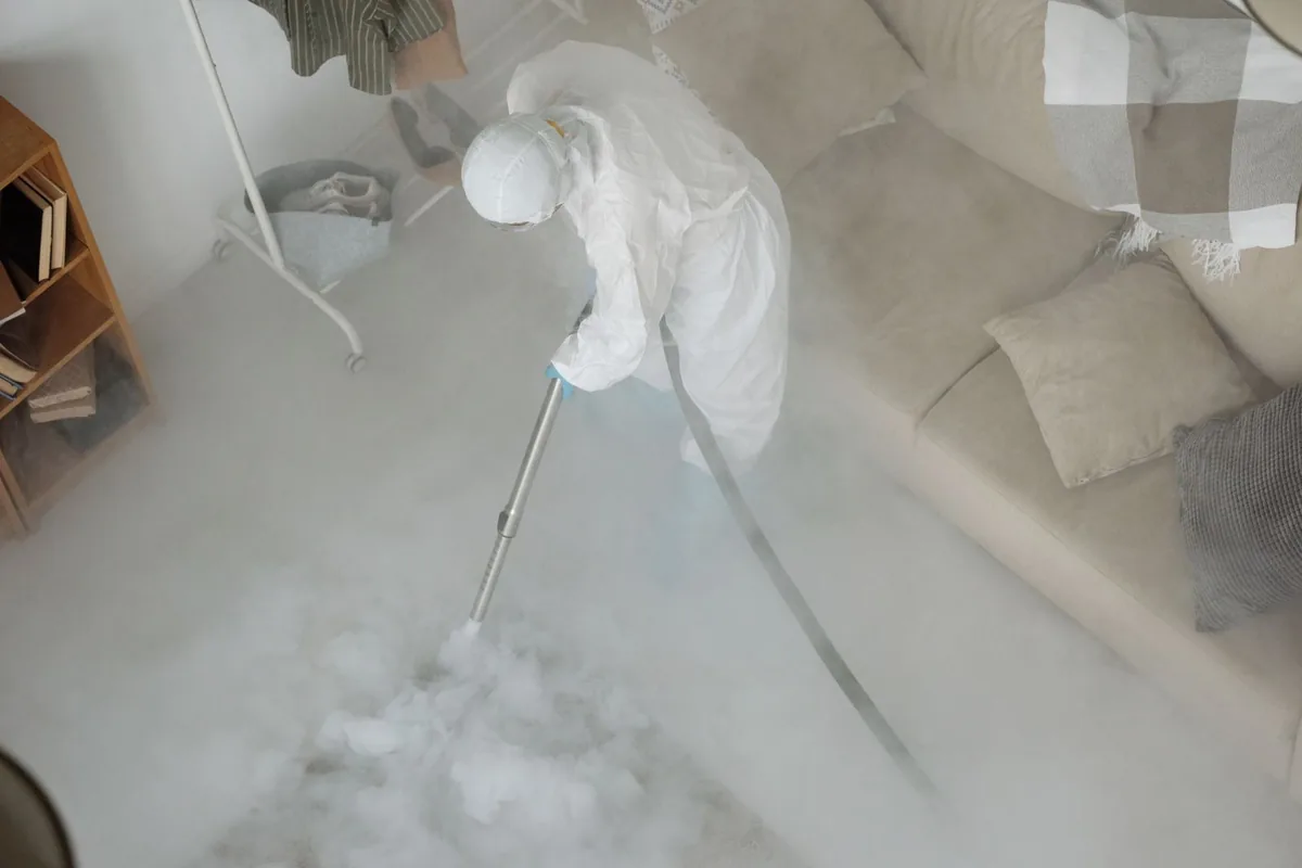 Biohazard cleanup technician in protective equipment, Hurley, NM